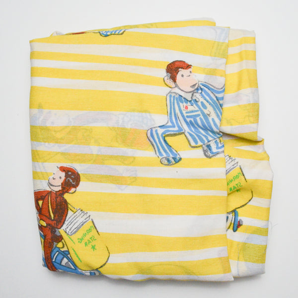 Curious George Woven Sheeting Fabric - 52" x 72"
